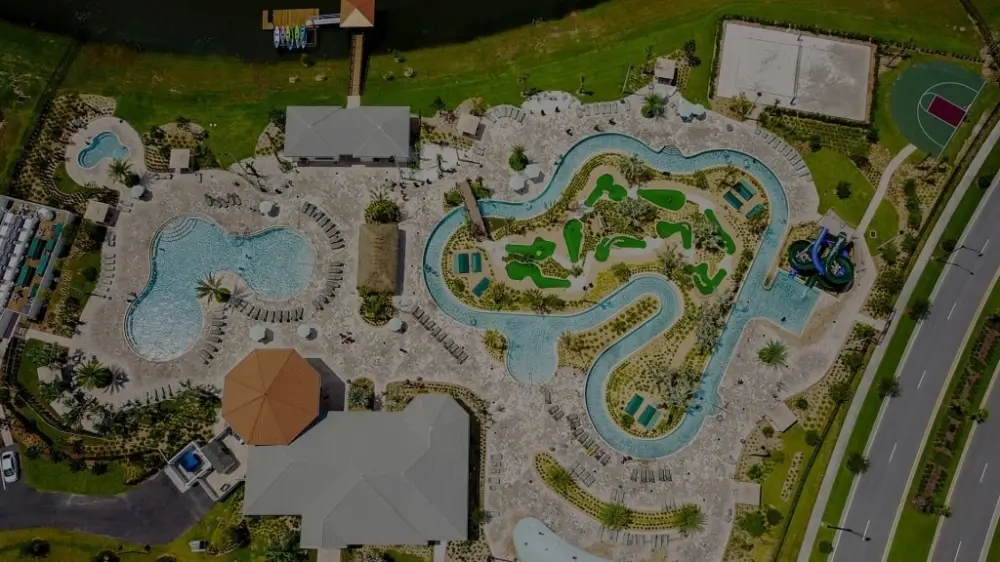 Aerial view of Storey Lake Resort clubhouse, lazy river, water slides, splash pad, and pool complex