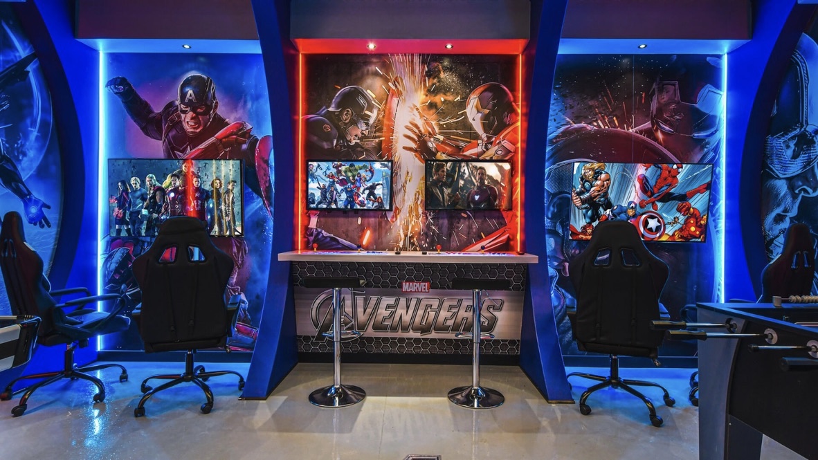 Avengers themed game room with gaming stations and blue LED lighting