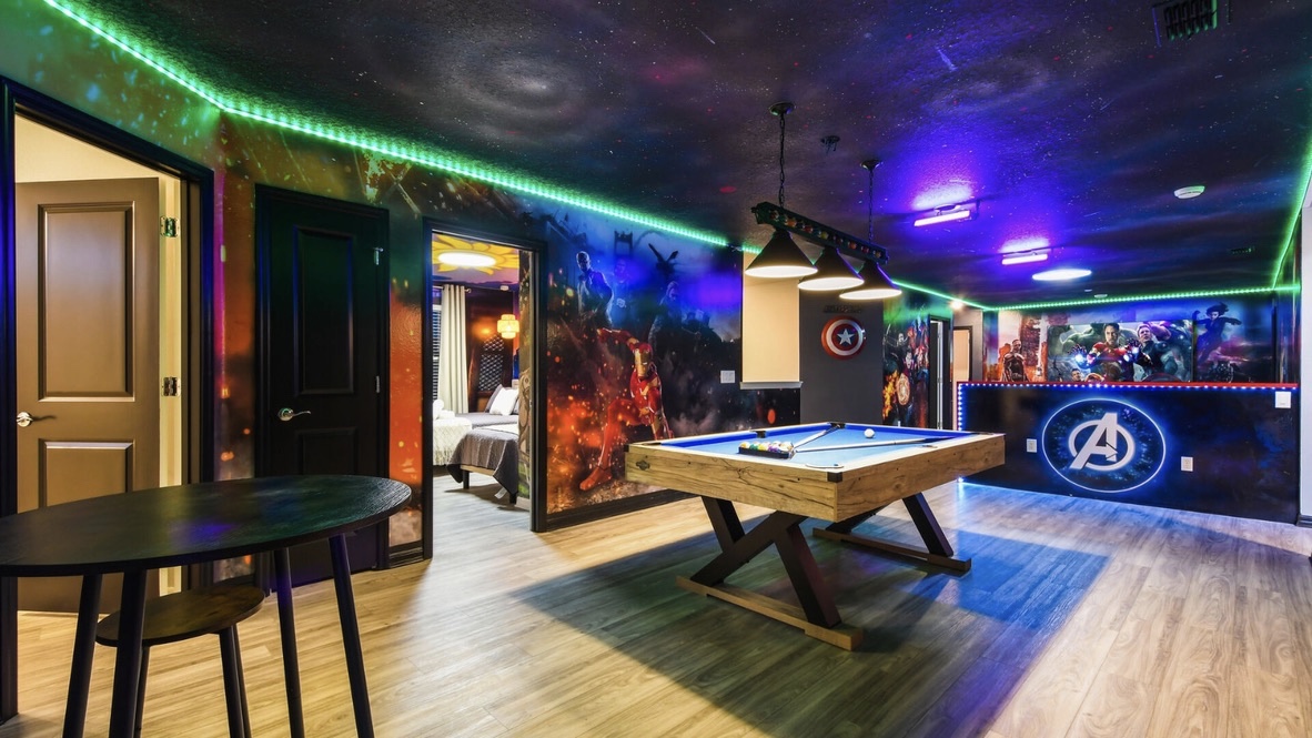Avengers themed pool room with neon lighting and murals