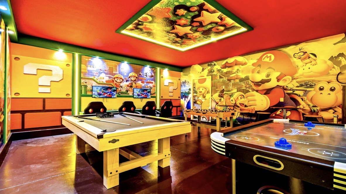 Super Mario themed game room with air hockey and foosball
