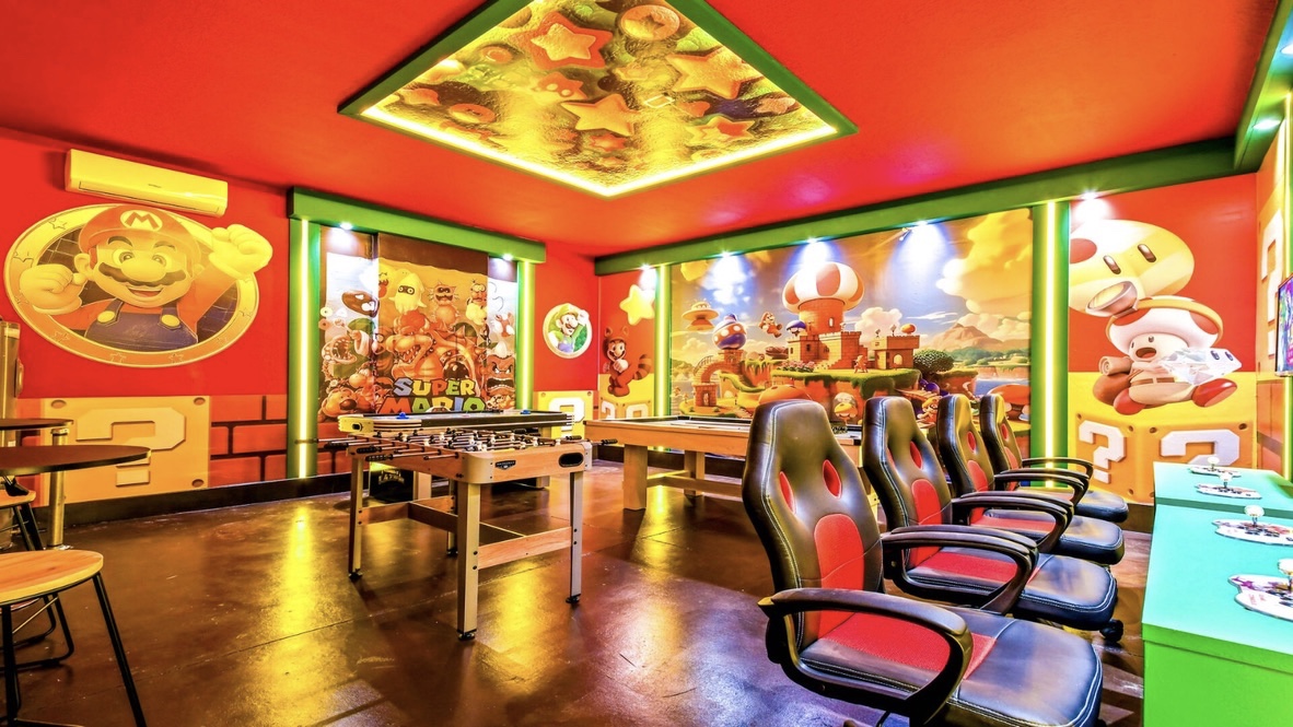 Super Mario themed entertainment room with foosball and gaming