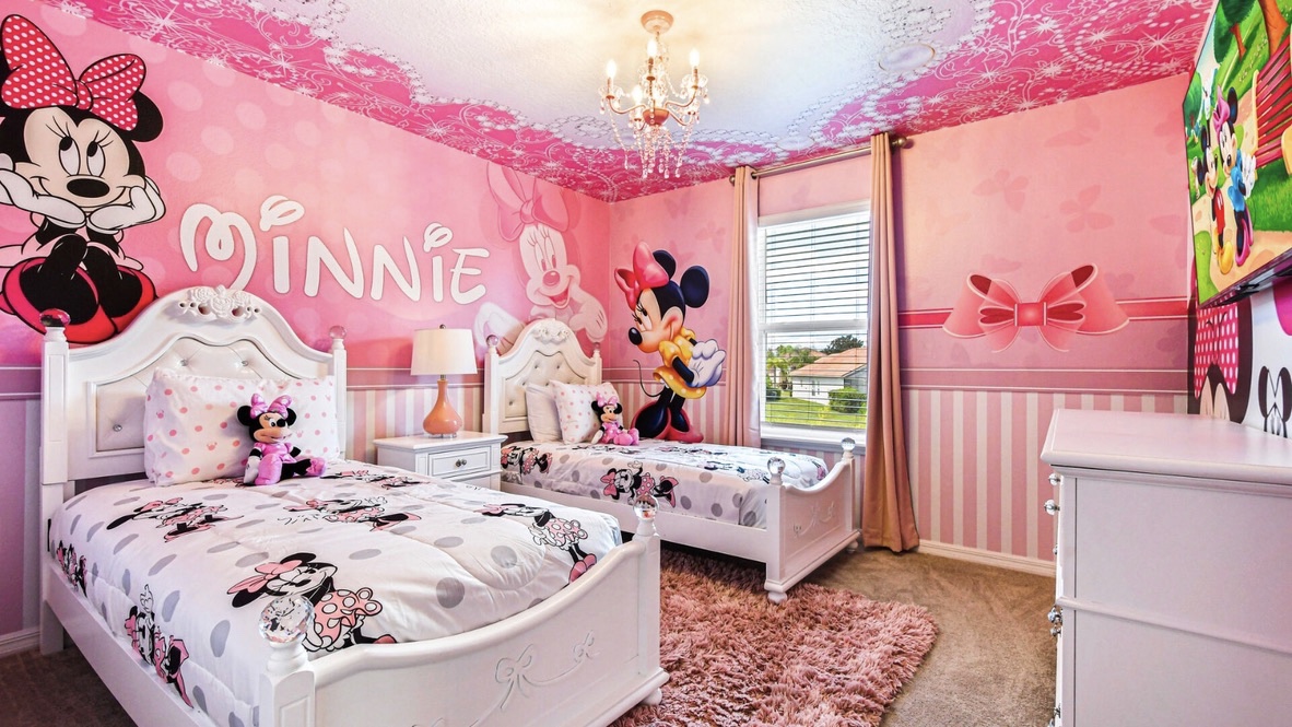 Minnie Mouse themed kids bedroom with custom bedding and wall murals
