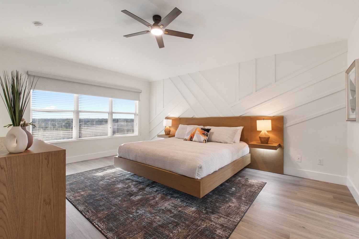 Elegantly staged master bedroom with king bed